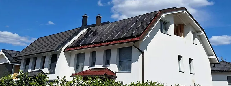 10hoch4 Photovoltaik GmbH – weißes Einfamilienhaus mit Photovoltaikanlage auf dem Satteldach