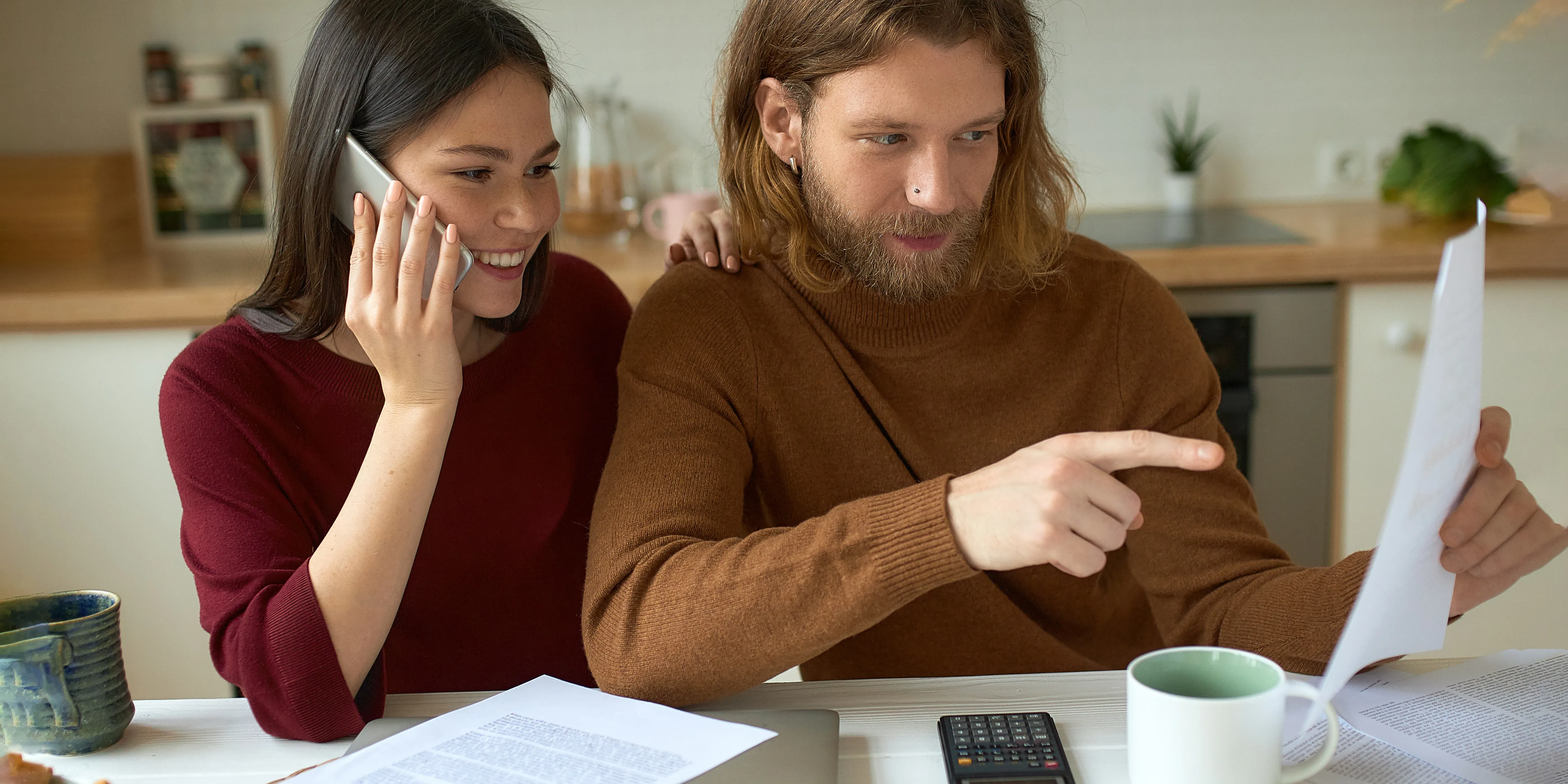 Couple reviewing documents together while one points at paper.