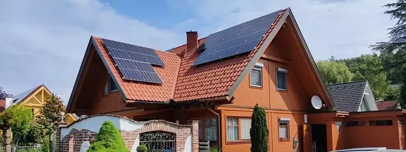 ETR-Energietechnik GmbH – Holzhaus mit Photovoltaikanlagen auf beiden Giebeldächern.