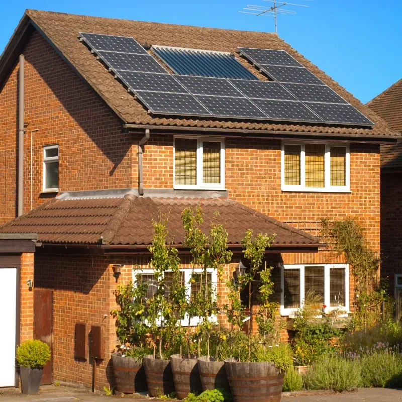 Brick house with solar panels installed on roof.