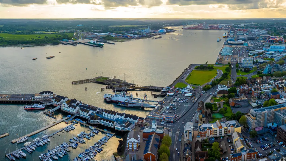 Aerial view of Southampton port with moored ships, waterfront buildings, and industrial docks.