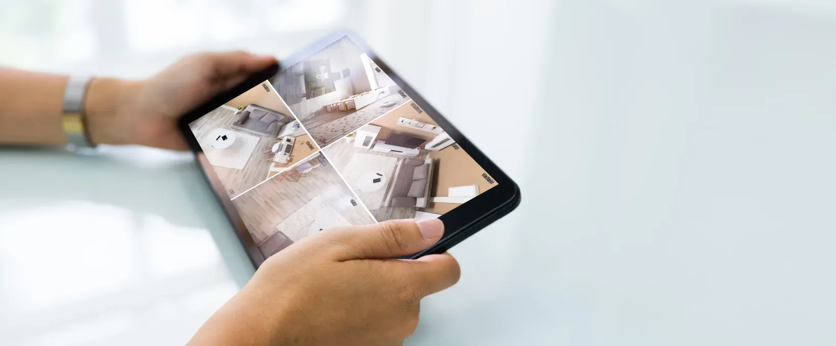 Person holding smartphone displaying apartment floor plan layout with multiple rooms.