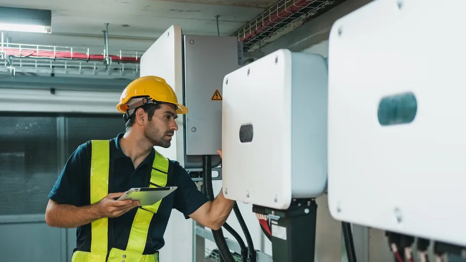 Electrician inspecting a home battery storage unit