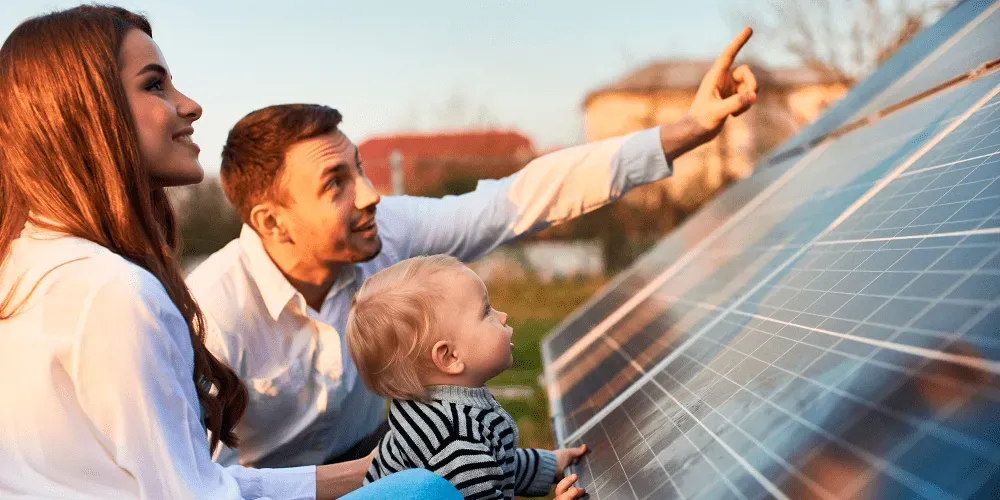 Family pointing at solar panels for Irish homes on a rooftop.