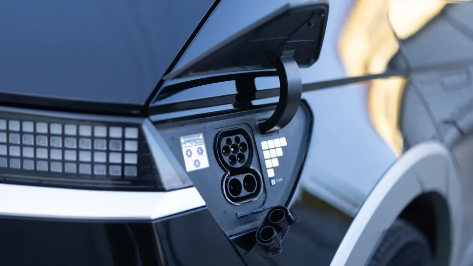 Pictured is a charging port on a black electric car.