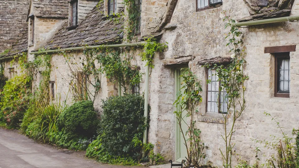County Mayo: stone cottage with green door along rural pathway.