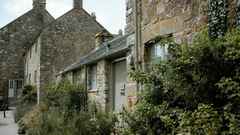 Traditional stone cottages with lush garden greenery in County Cavan, Ireland