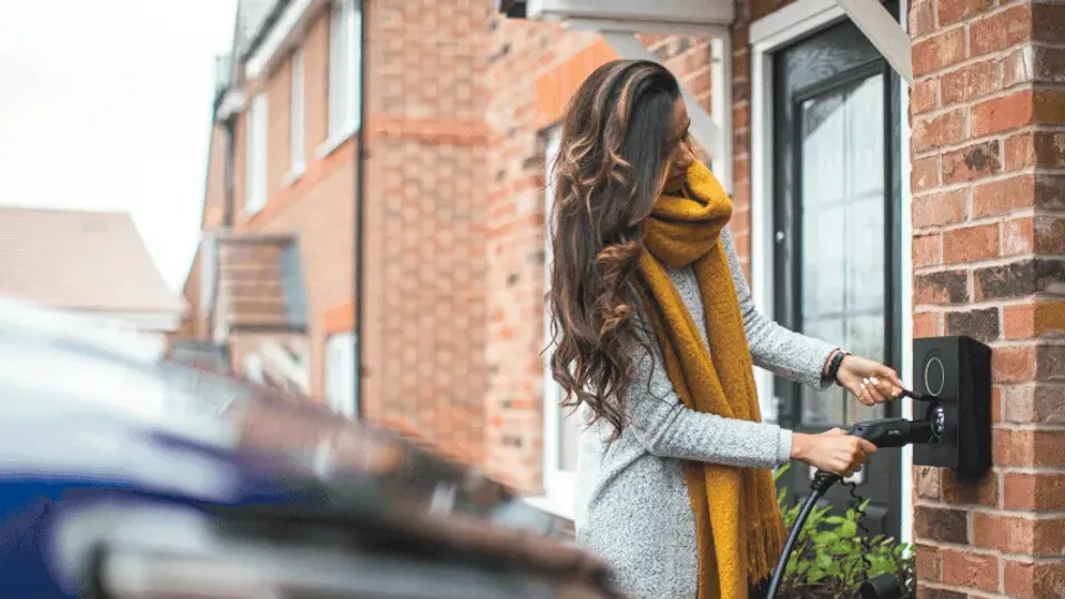 Woman holding EV charger