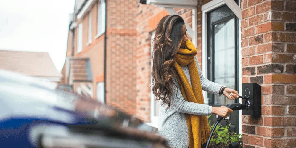 Woman holding EV charger