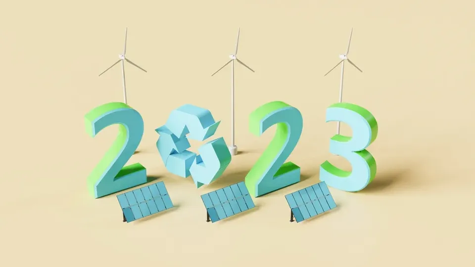 Numeri 2023 con turbine eoliche, pannelli solari e simbolo di riciclaggio che rappresentano energia rinnovabile e sosten.
