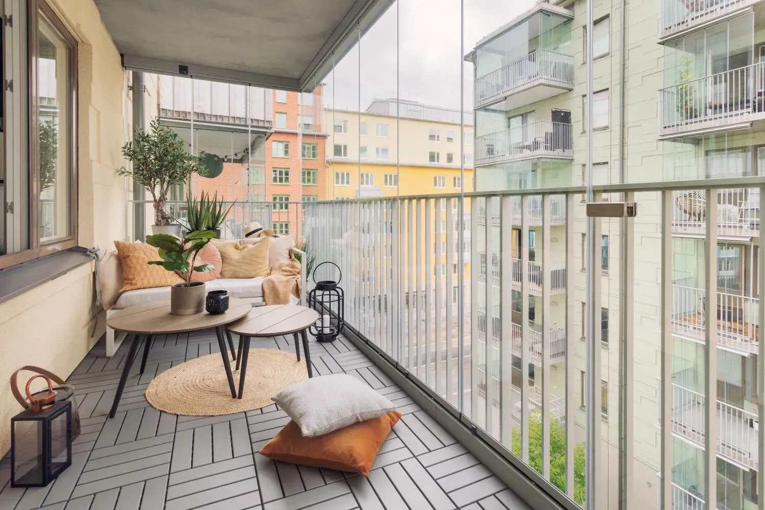 Möblerad balkong med utsikt över bostadshus.