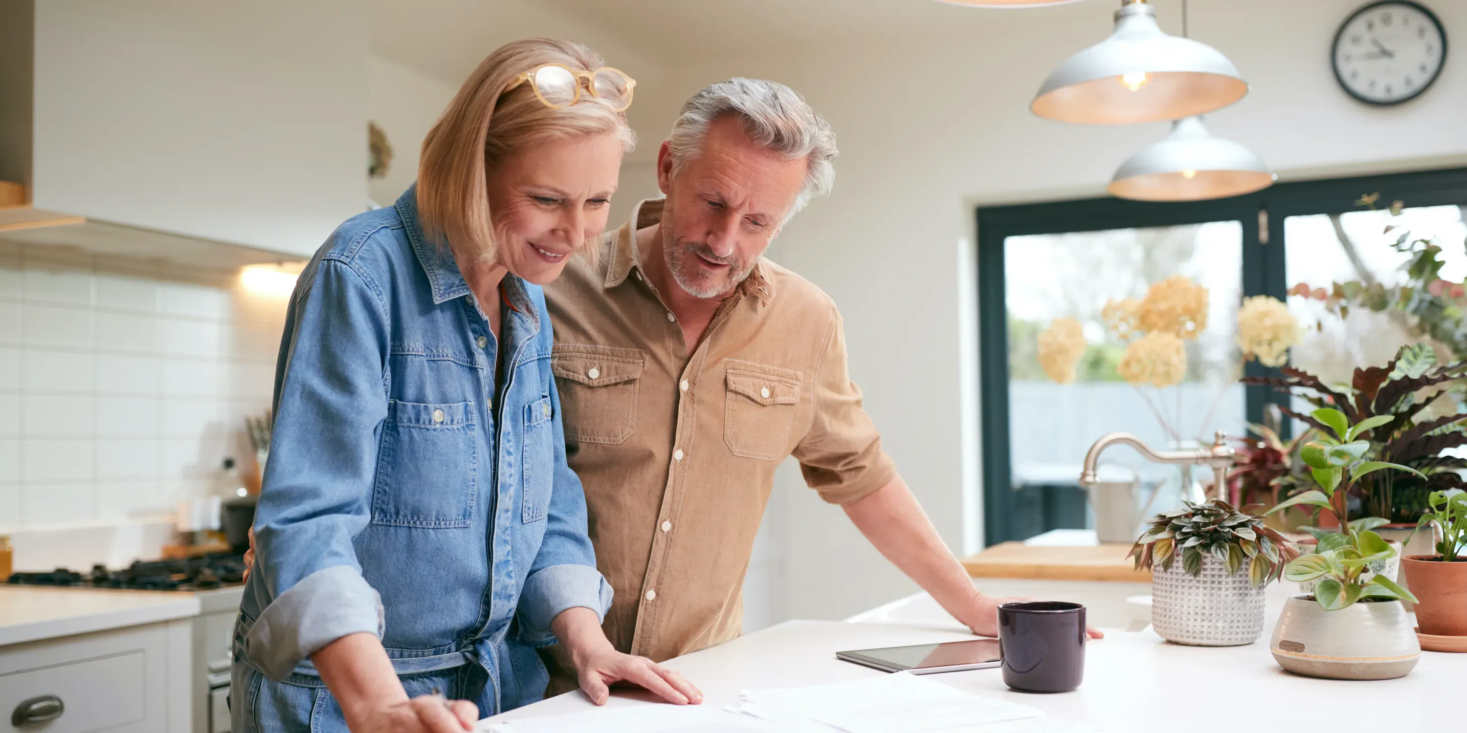 Mature couple reviewing documents at home