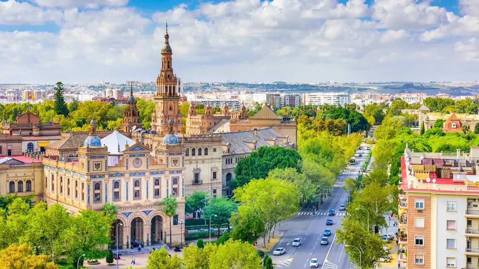 Vista aérea del paisaje urbano de Sevilla con catedral ornamentada y edificios históricos.