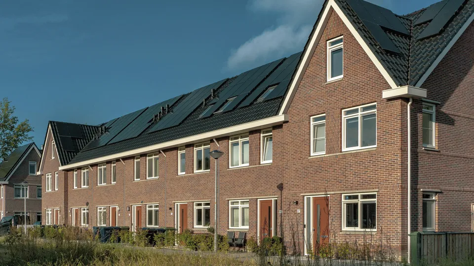 Row of brick terraced houses with solar panels on the rooftops in County Laois, Ireland