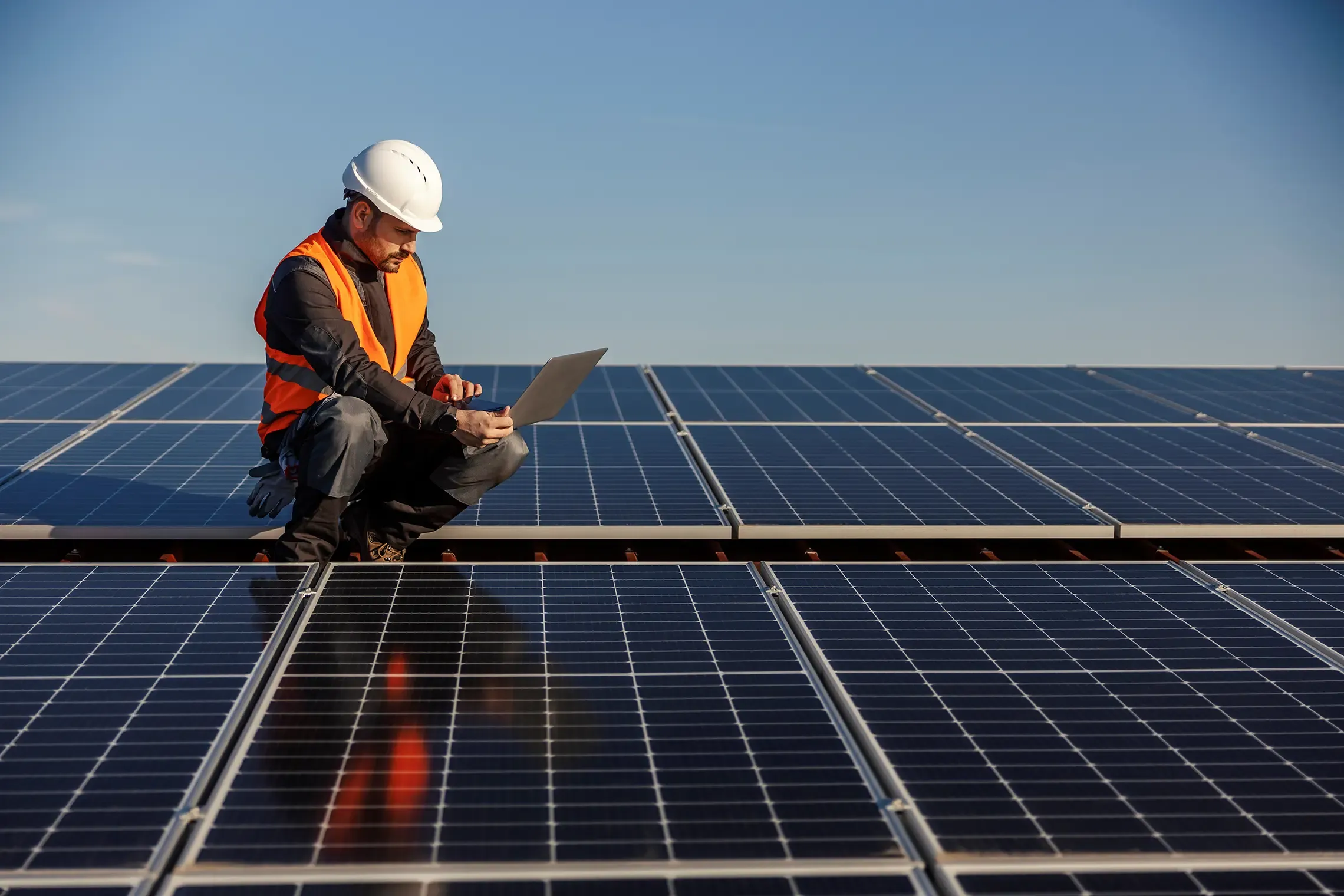 Solar installer checking solar panels that he has just installed