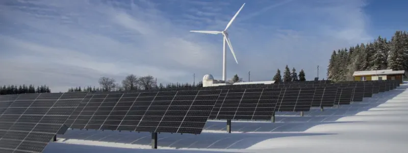 Painéis solares e turbina eólica em paisagem nevada.